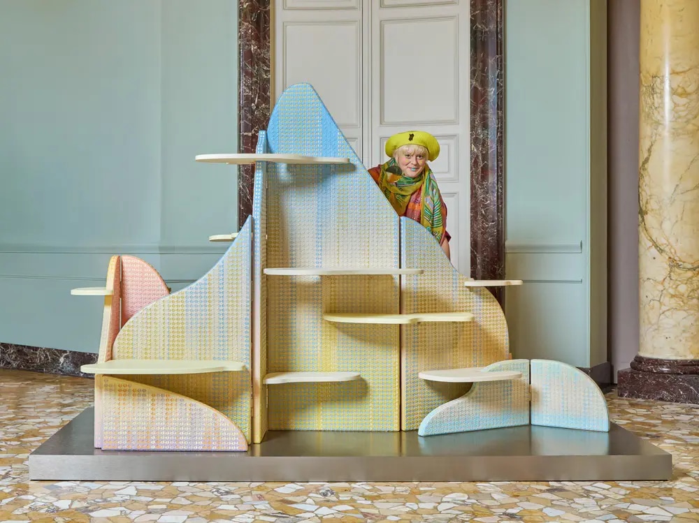 British designer Bethan Laura Wood standing behind the paravent