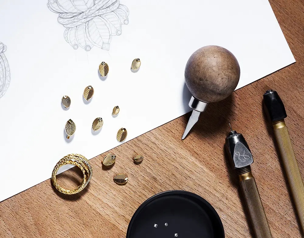 A piece of jewellery, tools and a sketch