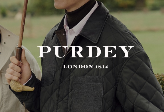 Purdey logo with a person in a jacket in the background