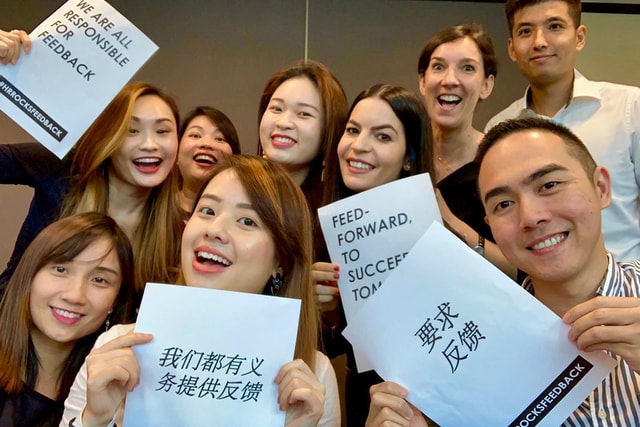 A photo of group of people in an office